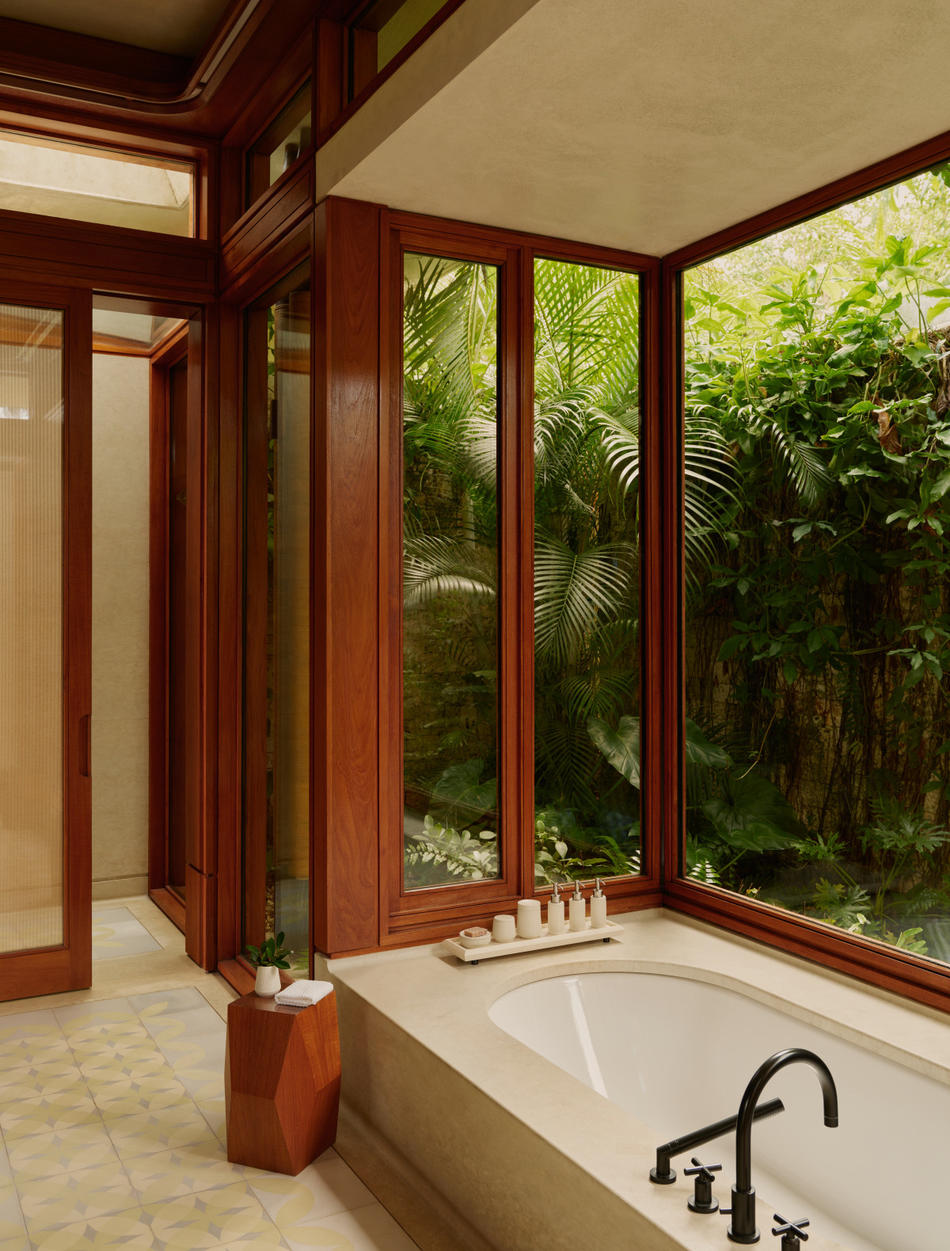 Amanera — bathroom with corner glazing onto the surrounding jungle
