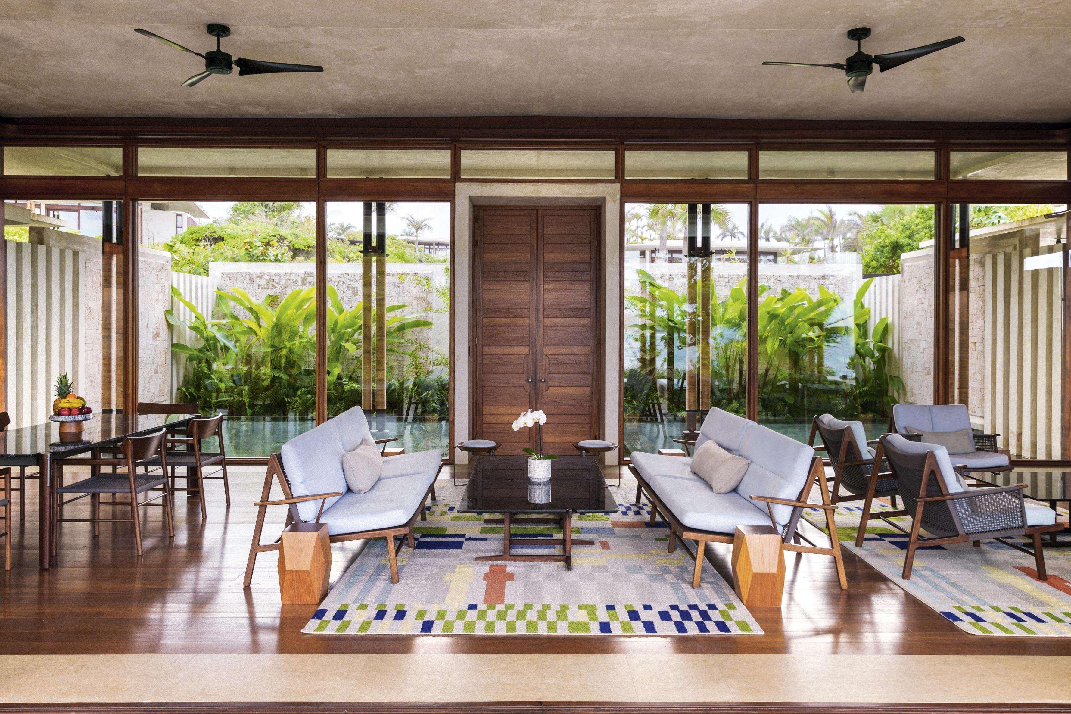 Amanera — central lounge with hardwood frames opening onto the garden