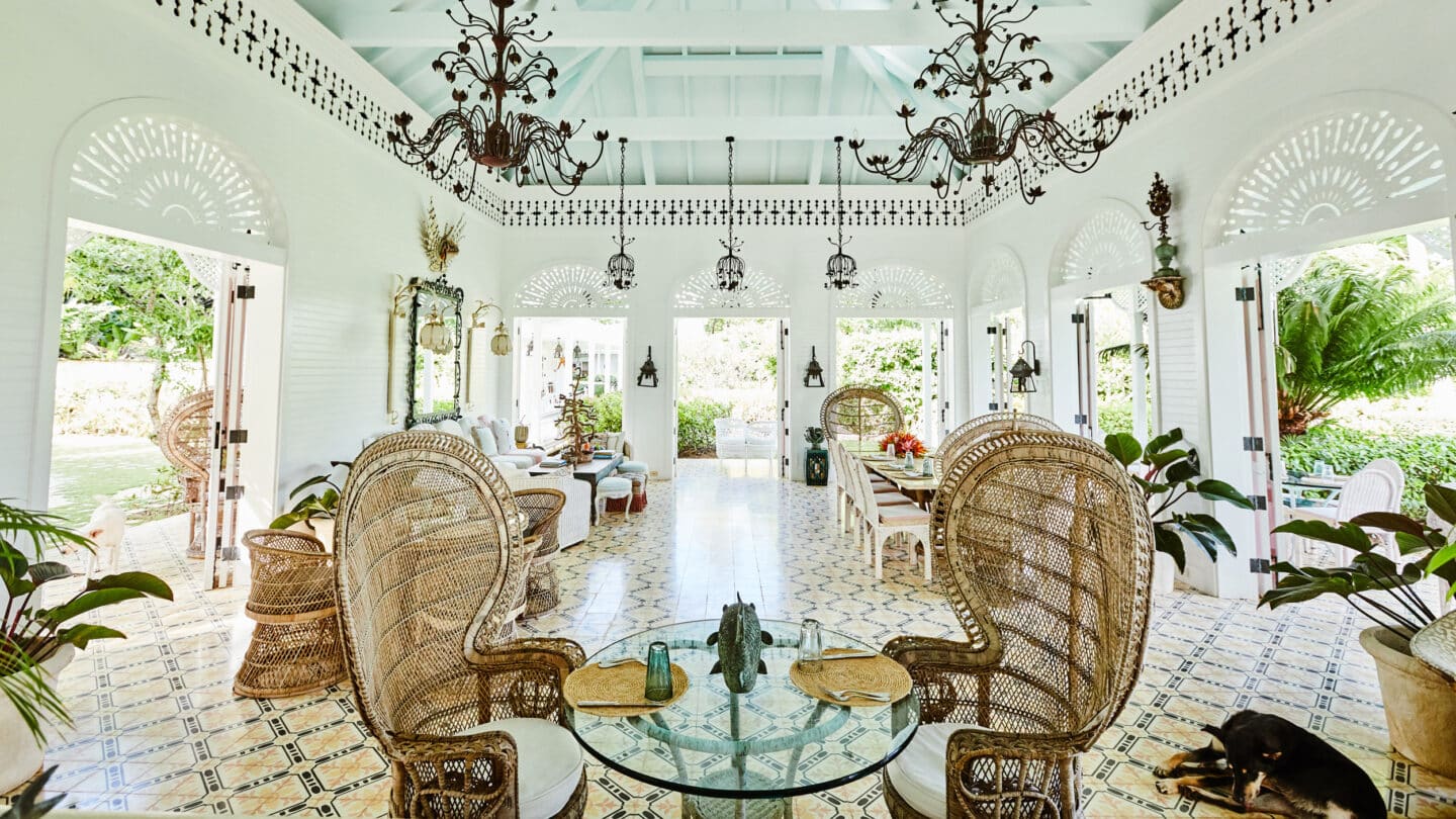 Playa Grande Beach Club — pavilion interior with patterned tile, peacock chairs, and chandelier ceiling