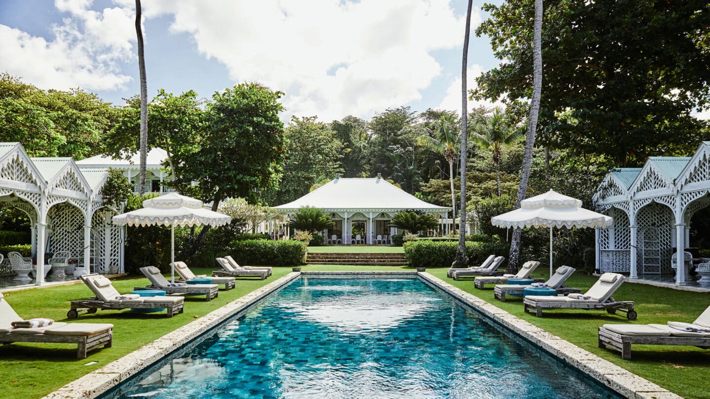 Playa Grande Beach Club — main pavilion and pool framed by lattice cabanas